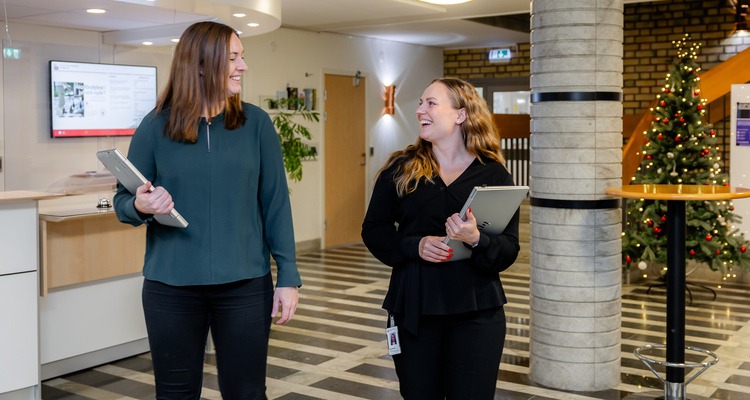 Två hr-konsulter går genom kommunhusets reception.